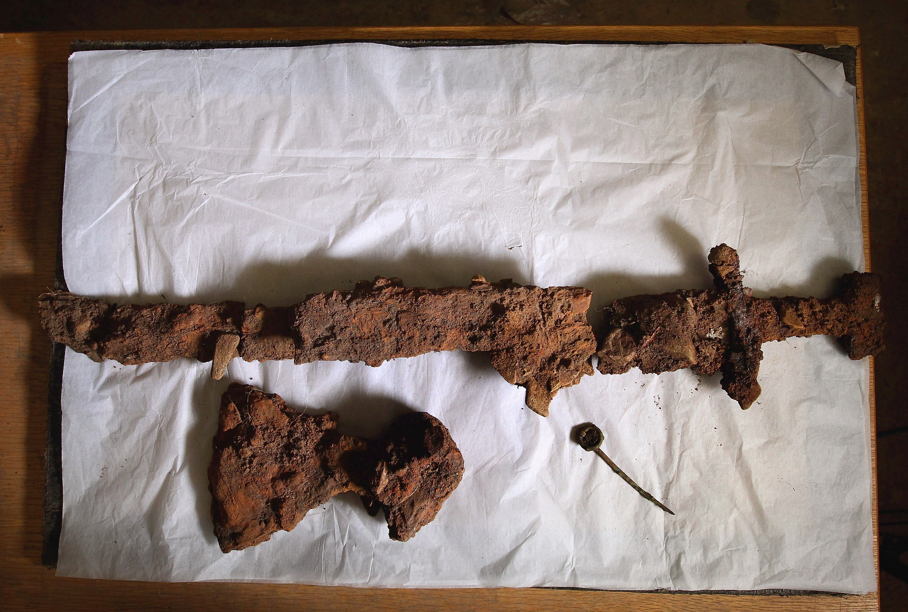 A Viking sword, axe head and bronze ring pin on display in Milton Keynes