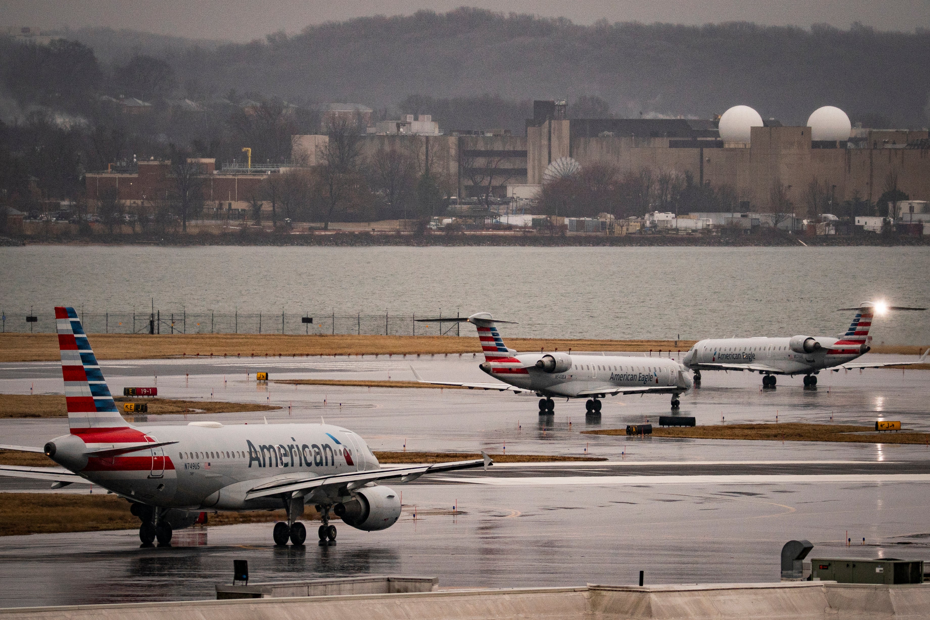 American Airlines jets sit on the runway at Ronald Reagan National Airport. Two jets hit each other on Thursday afternoon, with several lawmakers on board one of the planes