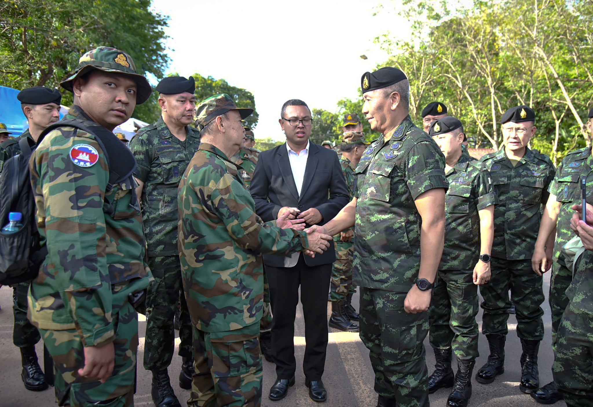 Royal Thai Army commander-in-chief General Pana Klaewplodthuk (R) and Cambodian General Mao Sophan (L) shaking hands at the Thai-Cambodian border in Kap Choeng district, Surin province, Thailand, 29 May 2025