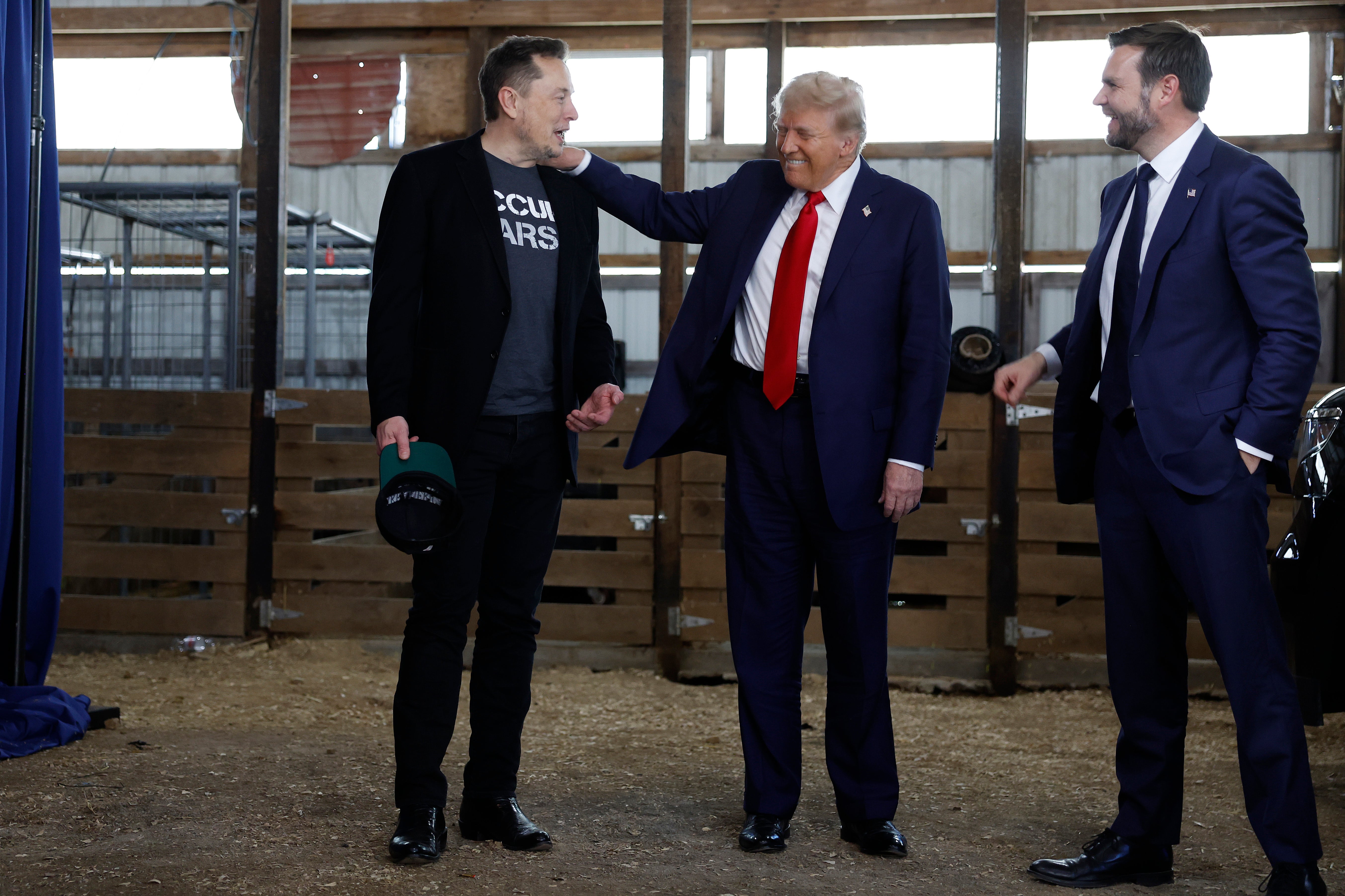 Republican presidential nominee, former President Donald Trump (C) visits with Elon Musk (L) and Republican vice presidential candidate Sen. JD Vance back stage during a campaign rally at the Butler Farm Show grounds on October 05, 2024 in Butler, Pennsylvania.