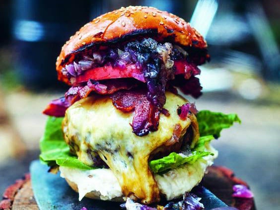 DJ BBQ’s ultimate cheeseburger is stacked high with onions, Monterey Jack cheese, romaine lettuce, horseradish root and more (D
